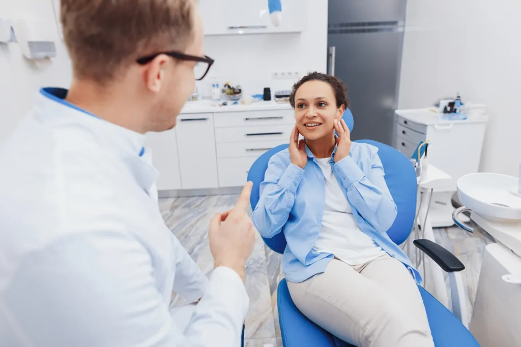 Smiling woman discussing dental hygiene with her dentist at Big Sky Family Dental.