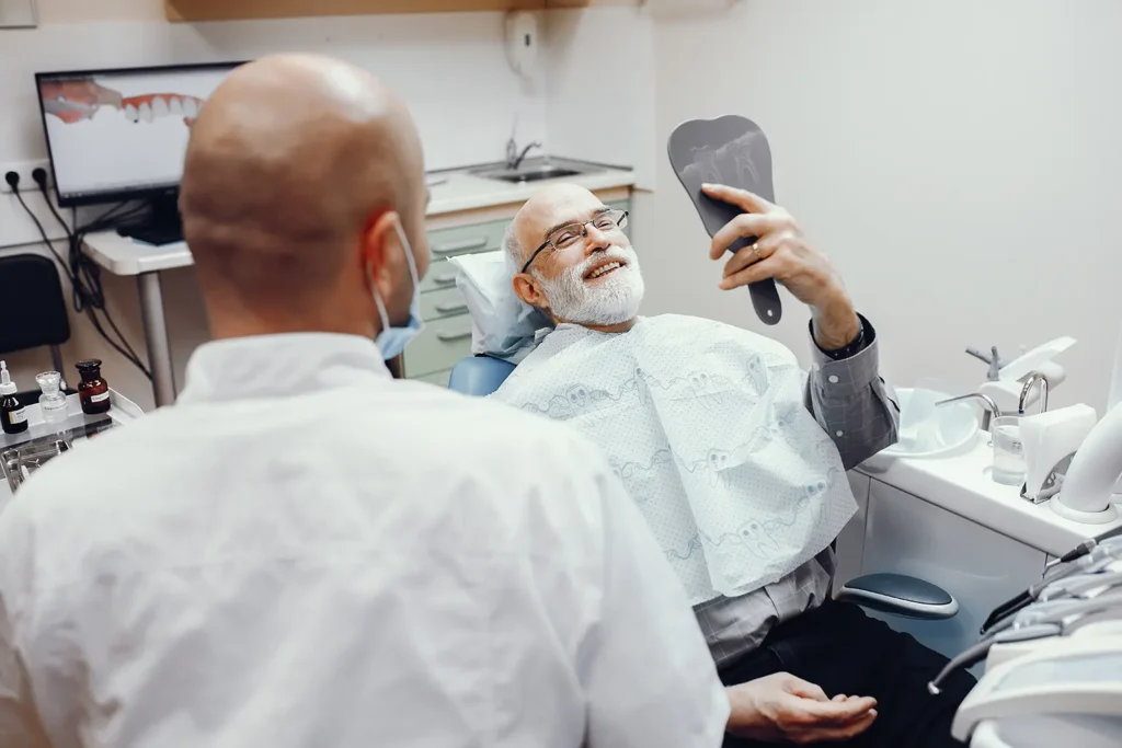 Older man with diabetes discussing oral health with his dentist at Big Sky Family Dental.