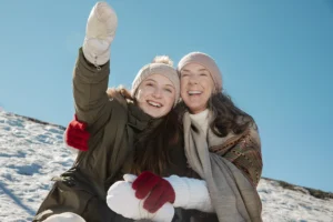 A happy family enjoying winter outdoors, demonstrating how to prevent teeth sensitivity in cold weather with tips from Big Sky Family Dental.