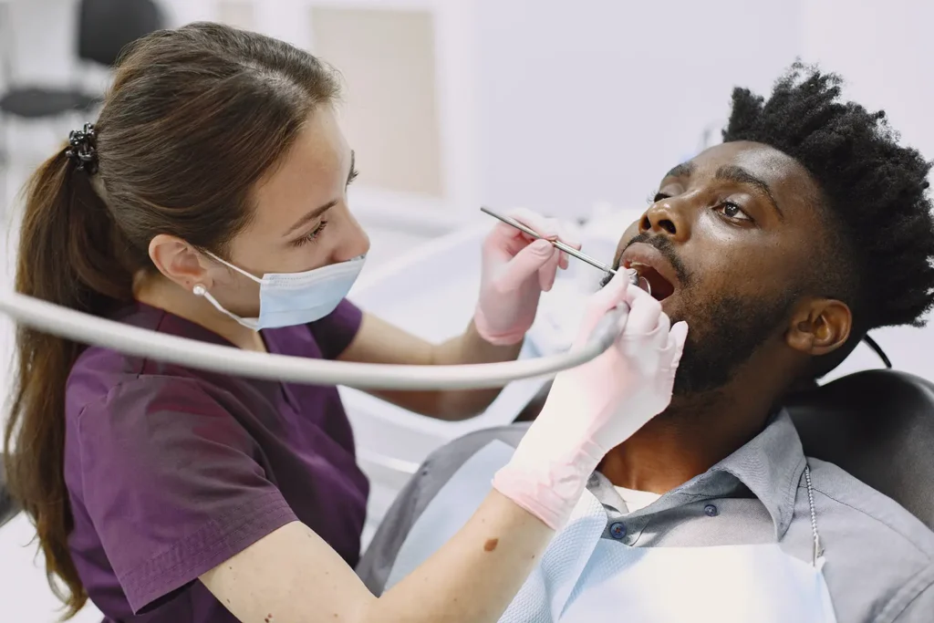 A dentist providing dental hygiene care to a patient at Big Sky Family Dental, highlighting the importance of regular check-ups for a healthy smile.