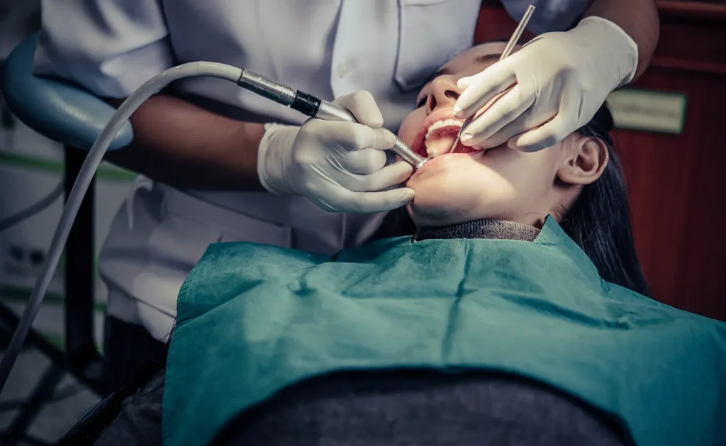 Dentist performing a dental filling on a patient, highlighting the procedure and cost at Big Sky Family Dental.